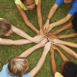 Unity - Top view of multi ethnic children lying with their hands together